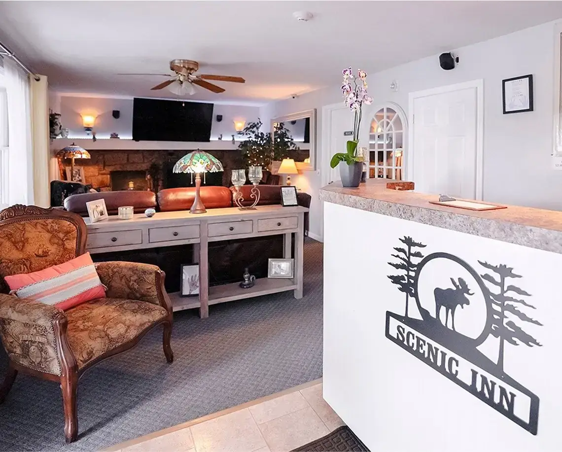 Scenic Inn front desk and lounge with a stone fireplace