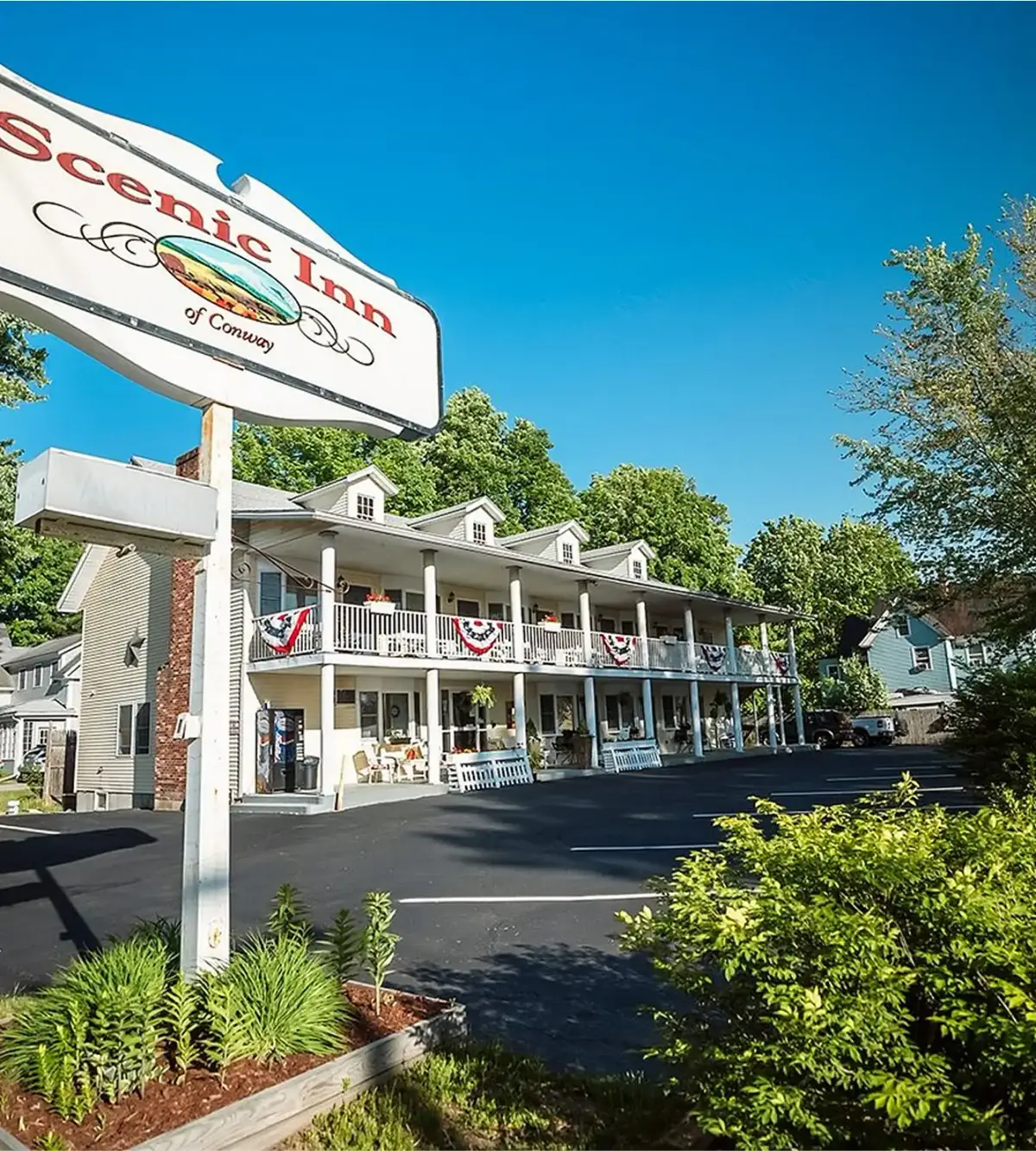 Scenic Inn of Conway sign in front of the inn, with balconies on the upper floors